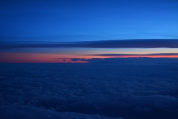 flying above the clouds in the evening