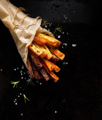 French fries,  baked fries from different types and colors of potatoes sprinkled with herbs and...