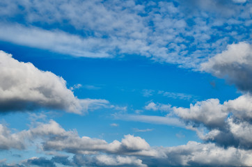 Blue sky background with white clouds. Blue sky and clouds. Beautiful cloud scape over horizon.