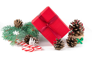 Christmas composition on white background with beautiful Christmas gift boxes, snowy fir branches, conifer cones, holiday decor