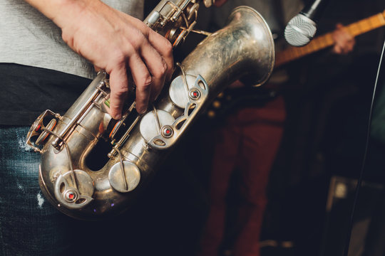 Saxophone Player Jazz Musician. Saxophonist With Baritone Sax Player.