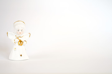 Ceramic angel figurine on a white background, Space for text