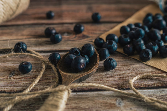 Tasty bilberry on wooden surface