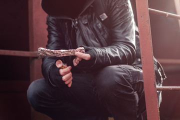 Drug addict smoking opium on tin foil