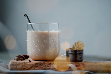 Indian masala chai tea, spiced tea with milk on rustic wooden desk, selective focus, copy space