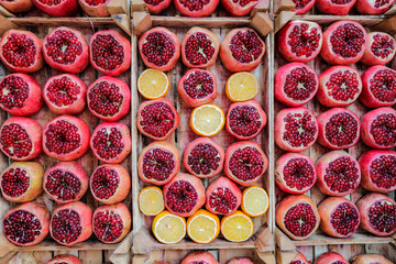 Pomegranate backgrounMany Pomegranate and a number of oranges cut in half .