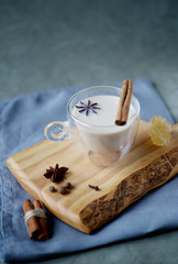 Indian masala chai tea, spiced tea with milk on rustic wooden desk, selective focus, copy space