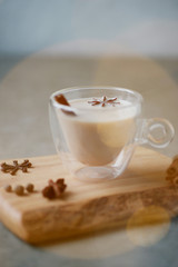 Indian masala chai tea, spiced tea with milk on rustic wooden desk, selective focus, copy space