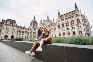Women sitting near ancient old building