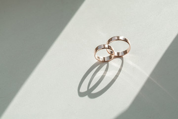 Wedding rings on wedding card on a white background, two golden wedding rings isolated on white,...