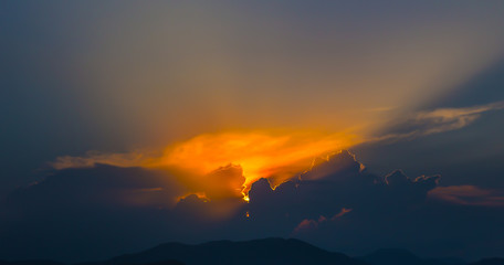 Majestic sunset in the mountains landscape with sunny beams.