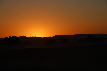 Orange sky from the Berber camp of the Merzouga desert in the Erg Chebbi Dunes. Morocco