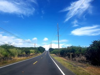 Fototapeta na wymiar road hawaii blue sky with clouds