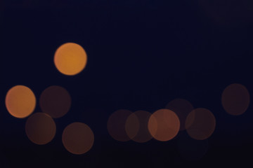 blurred colorful circle lights on the dark background, city light, abstract composition.