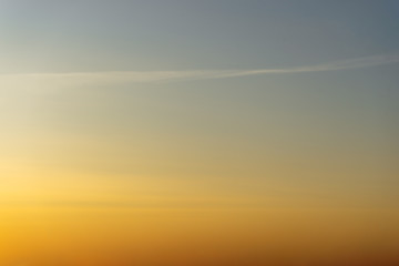 Beautiful clear, morning sky at sunrise, natural background. Soft gradient from orange to blue.