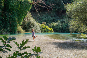 The Blue Eye (Albanian: Syri i Calter) is a water spring and natural phenomenon occurring near the village of Muzine in Finiq municipality, Albania. Young slim sexy girl posing in the water.