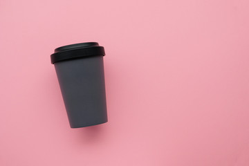 Reusable stylish eco friendly gray bamboo cup on pink background. Space for text. Flatlay, top view. Bring your own cup concept. Reduce plastic waste, sustainable lifestyle. Mock up.