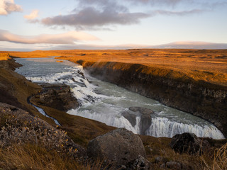 Fototapeta na wymiar View from the top of the canyon of the breathtaking Gullfoss Waterfall. A powerful two-tier waterfall, considered the most dramatic of Iceland. Iceland.