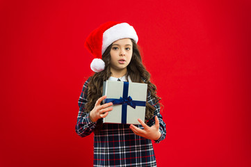 i want it to be mine. Happy winter holidays. Small serious girl. Little girl child in santa red hat. New year party. Santa claus kid. Present for Xmas. Childhood. Christmas shopping