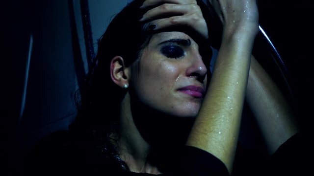 Sad woman at night sitting in shower dressed feeling depressed closeup