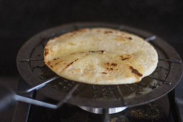Toasting a colombian arepa on a grill