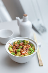 Chirashi Sushi Rice Bowl. Japanese Appetizer with Burnt Salmon, Edamame Soybeans, Avocado and Rice