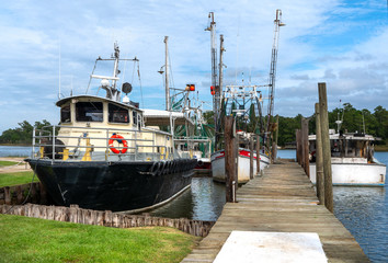 Fishing boats docked at harbor in small fishing village 