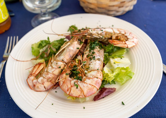 fried big shrimps with lettuce on white plate