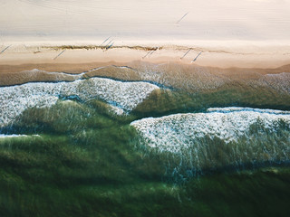 waves breaking on shore from above