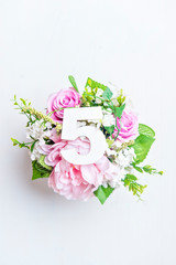 Layout with colorful flowers, leaves and number five. Flat lay. Top view.