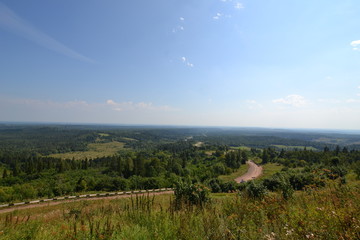 Naklejka premium summer day: road among the foothills of the Urals, view from the White Mountain
