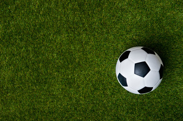 Top view of soccer or football on grass field - obrazy, fototapety, plakaty