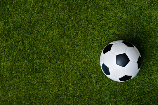 Fototapeta Top view of soccer or football on grass field