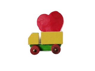 A wooden truck carrying the big red heart made from plasticine clay placed on a white background,...