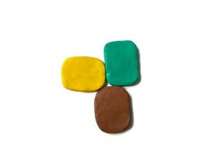 Colorful clay plasticine made are abstract shape placed on white background, arranged lumpy dough next to each other