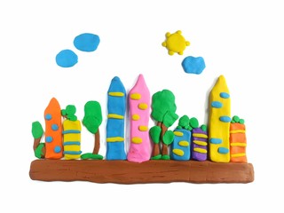 The city with fresh air is made from colorful clay plasticine on white background, many tall...