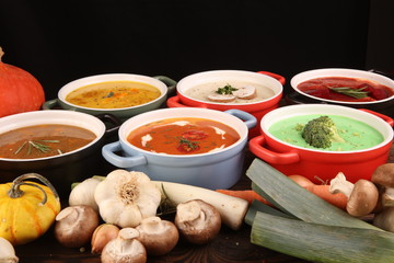 Variety of colorful vegetables cream soups and ingredients for soup. Concept of healthy eating or vegetarian food with mushrooms