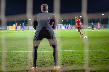 Goalkeeper catch the ball when defensive on goal during a football match