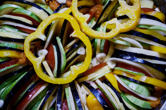 ratatouille culinary dish, vegetables arranged in a circle-cabbage roll, tomato, potato, bell pepper, eggplant, garlic, sauce © YULLA