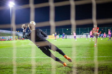 Goalkeeper catch the ball when defensive on goal during a football match