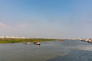 Obraz premium Looking downriver at sunset on Song Sai Gon River from downtown Ho Chi Minh City, Vietnam.
