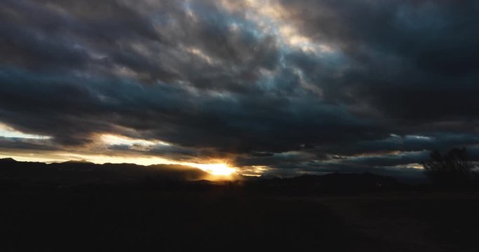 A golden sunset in the mountains with clouds near Málaga, Spain