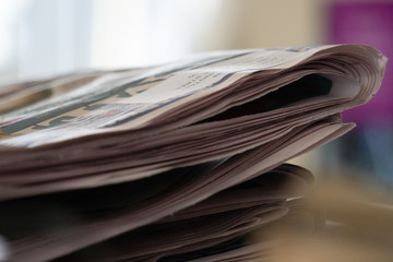 Stack of newspapers on white background. Close up photography.