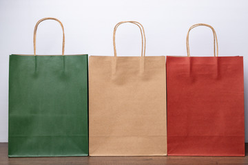 Green brown and red paper bags.