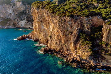 Beaituful cliff over blue mediterranean water during sunset