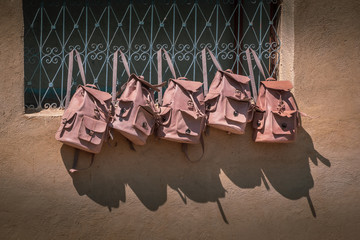 Landscape view of colorful barrels in a tannery in the old medina Finished leather bags drying on the wall. Fez, Morocco.