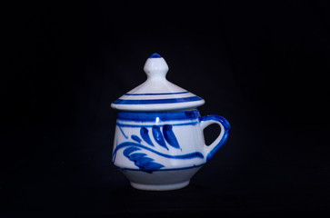 A closed Talavera vase with an elegant black background