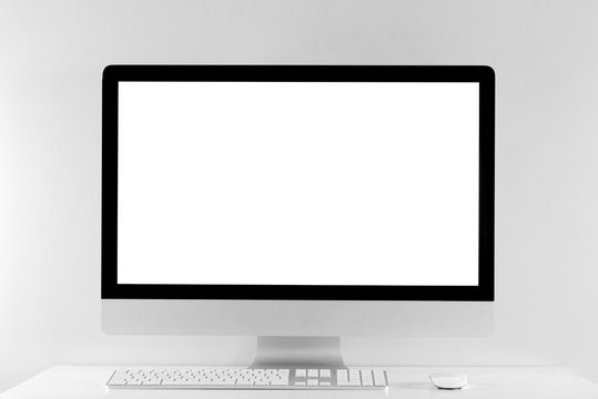 Computer all in one in office table with isolated white screen