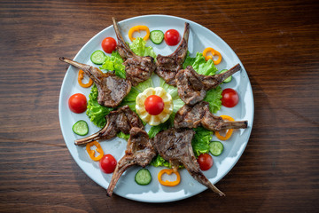 Juicy baked ribs with pork and veal meat. With vegetables.