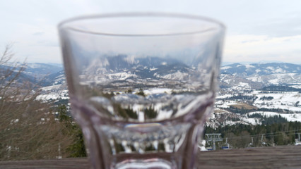 transparent glass on a snowy mountain landscape